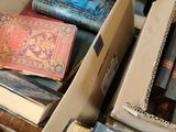 a box full of old books sitting on the floor