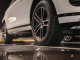 a close up of a car parked on a wet surface