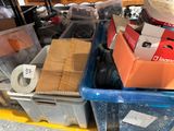 a pile of assorted items in a bin on the floor