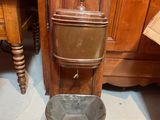 a toilet that is sitting next to a wooden cabinet