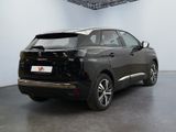 the rear end of a black car in a white room