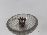 a glass candle holder with a candle inside of it