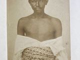 an old photo of a man with a basket on his chest