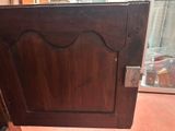 a wooden door with a handle on it in a room