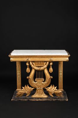 a gold and marble table with harps on it