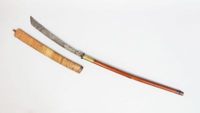 a knife and a wooden handle on a white surface