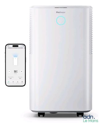 a white air conditioner sitting next to a smart phone