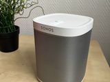 a close up of a table with a plant and a speaker on it