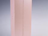two pink boxes are stacked on top of each other on a white surface