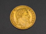 a close up of a gold coin on a black surface
