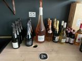 bottles of wine are lined up on a counter in a wine shop