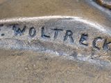 a close up of a statue of a dog with a name on it