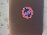 a brown laptop with a pink sticker on it