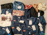 a lot of clothes that are sitting on a table
