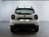 the rear end of a white car in a white room