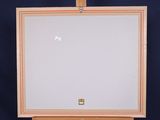an easel with a white board sitting on top of a wooden table