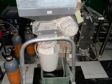 a toilet with a bucket on it in a room