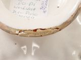 a close up of a white vase with writing on it