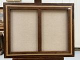 an image of an easel with a painting on it in a room