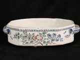 a white bowl with blue and yellow flowers on it