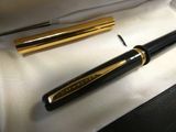a pen and a ballpoint pen sitting in a box