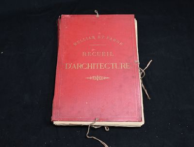 a red book that is laying on a black surface