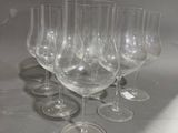 plusieurs verres à vin vides sont alignés sur une table