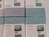 six sheets of bedding are stacked on top of each other on a table