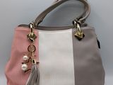 a close up of a purse with a tassel on it