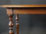 a small table with a wooden top on a black background