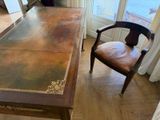 a wooden table with a leather chair in front of it