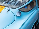 a close up of a blue and yellow car parked on the side of the road