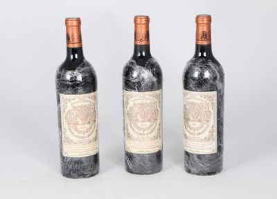 three bottles of wine sitting next to each other on top of a table