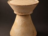 an image of a small wooden bowl on a black background