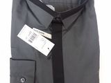 a black shirt with a black tie and a tag on it