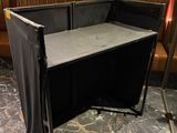 a table with a black cloth on it in the corner of a room