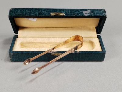 a pair of spoons in a box on a table