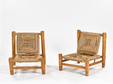 pair of mid - century chairs with woven seats and wooden frame