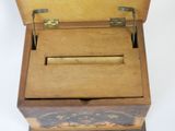 a small wooden box with a handle on it