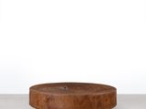une table ronde en bois avec un piètement en bois et un plateau blanc