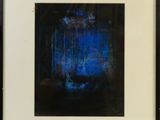 framed photograph of a blue and black abstract painting in a black frame