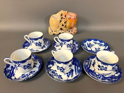 a group of blue and white china cups and saucers
