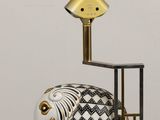 a figurine of an elephant and a lamp on a table