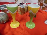 two wine glasses sitting on a table next to each other
