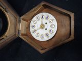 a wooden box with a clock inside of it