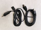 two black cables connected to a white wall with a white background