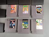 a lot of nintendo game cartridges sitting on a table