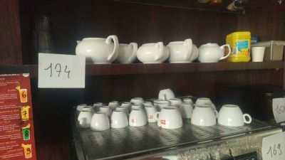 many cups and mugs on the shelves in the store