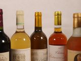 several bottles of wine are lined up in a row on a table