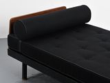 a black couch with a wooden frame and a black mattress